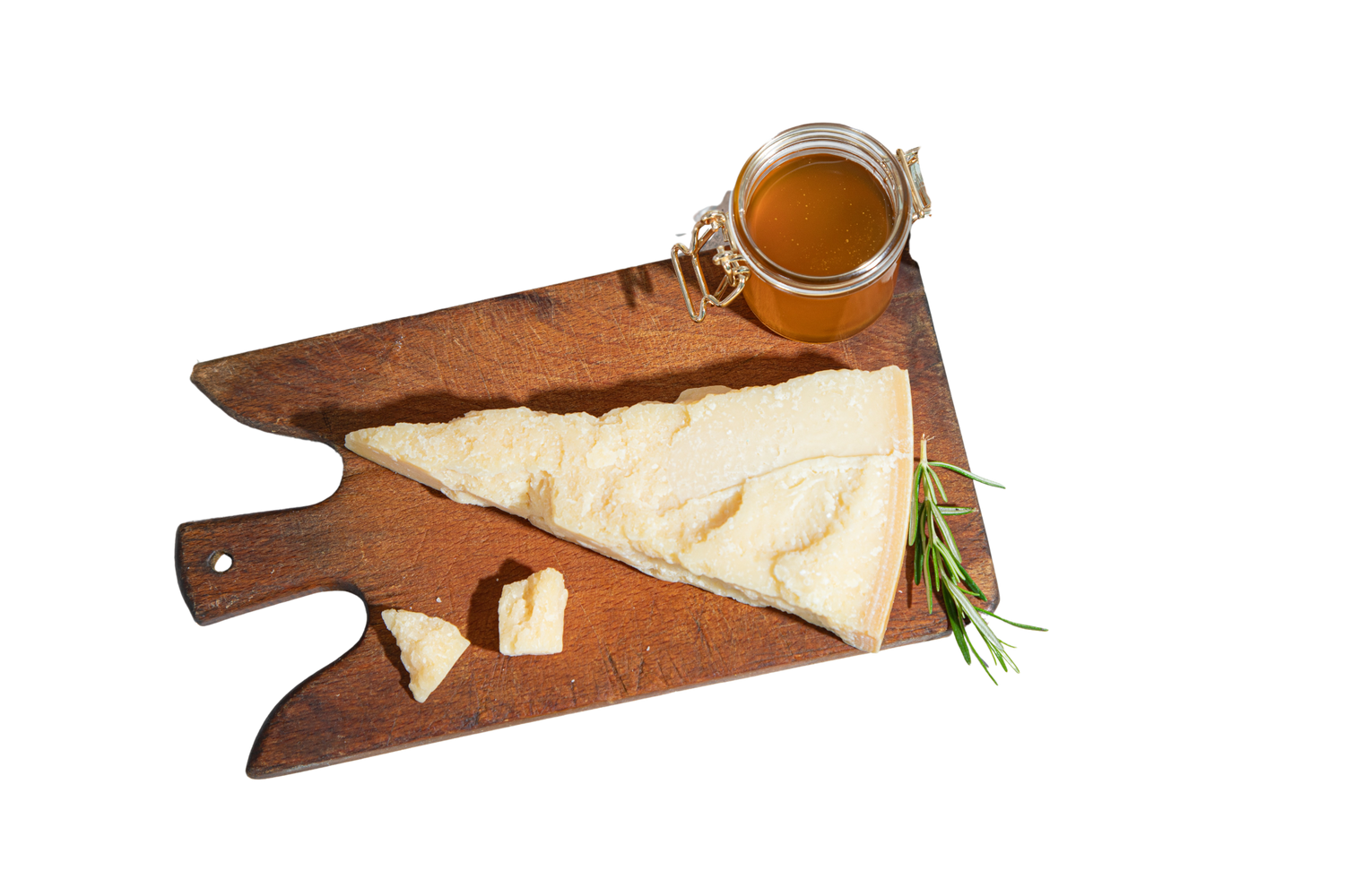 Wooden cutting board with cheese and a jar of honey on a white background