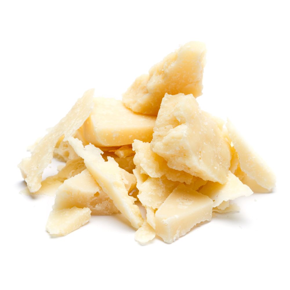 A pile of various cheeses displayed on a clean white background.
